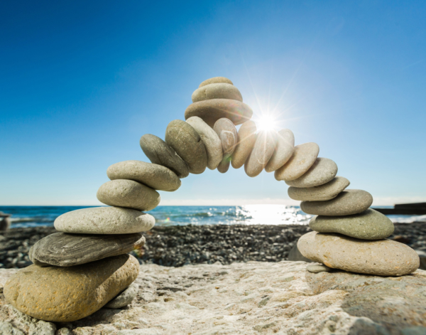 Arch of rocks stacked on a beach. 