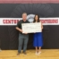 Hamilton employee awarding scholarship to a student