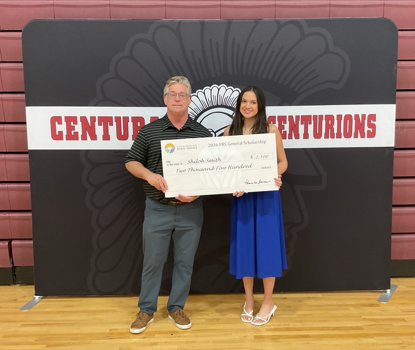 Hamilton employee awarding scholarship to a student